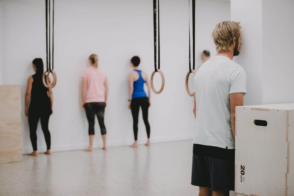 Group doing Spinal Waves against wall